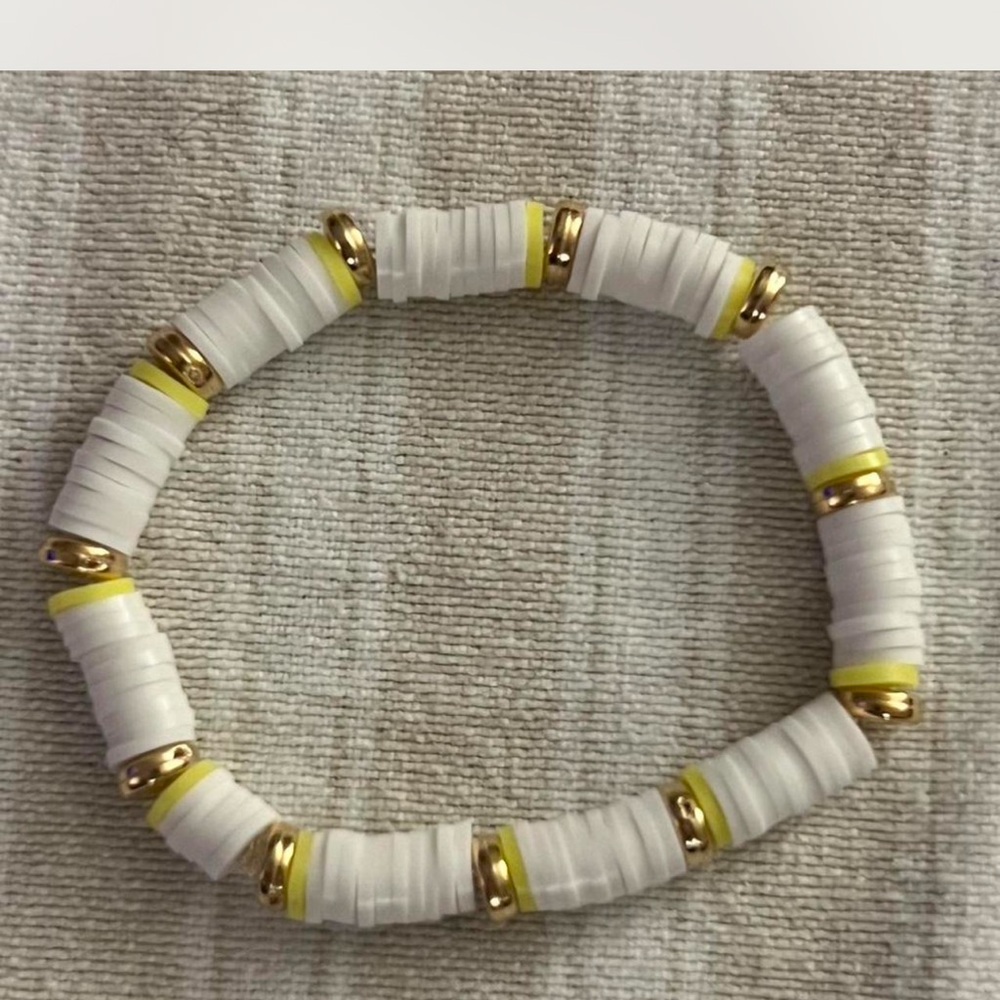 Handmade white and gold beaded bracelet featuring soft matte white heishi beads
